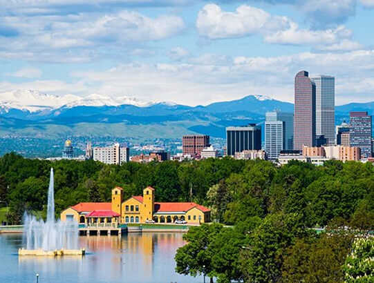 A lake with the Denver skyline the in the background.